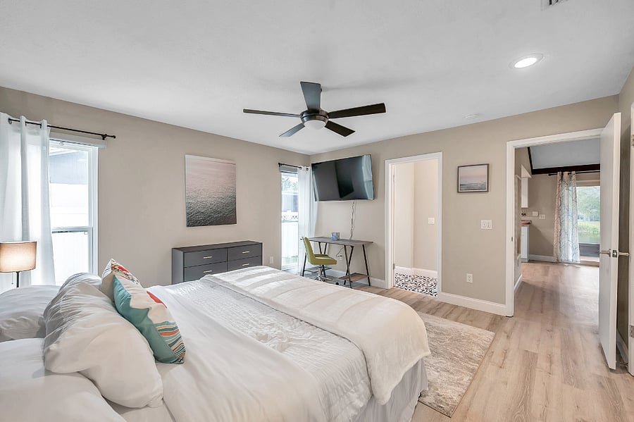 Primary bedroom w/ king bed and work station.