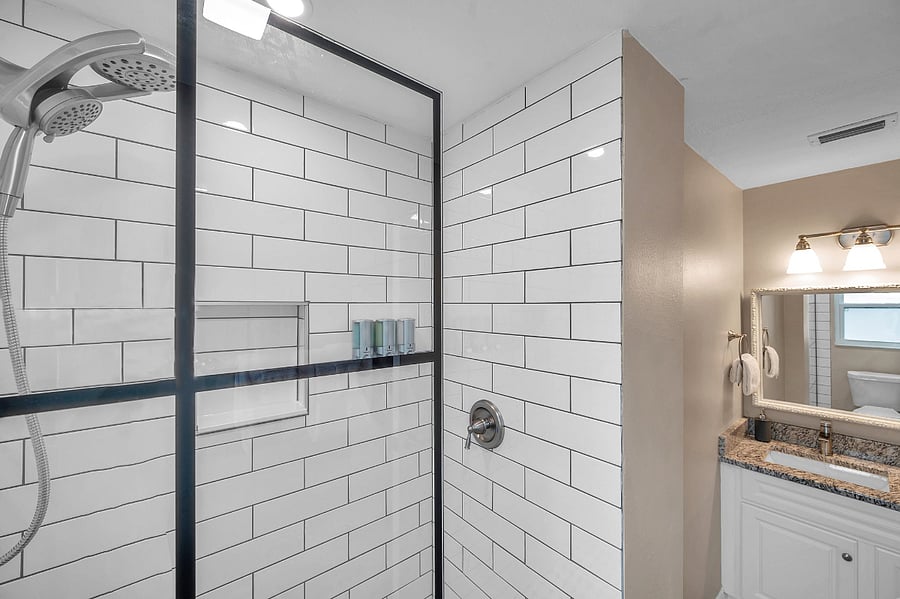 En suite bathroom for primary bedroom w/ walk in shower.
