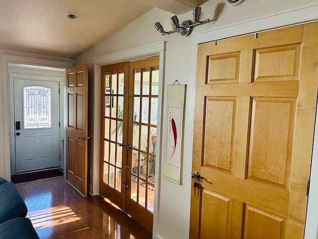 Maple door goes to large closet for cleaning supplies or other items.