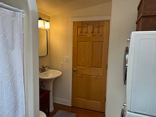 Warm bathroom with skylight, shower, laundry, and storage.