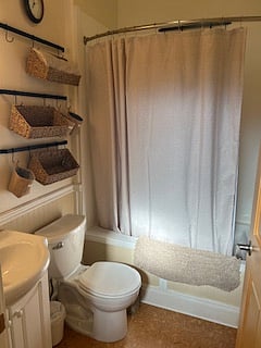 Bath attached to primary bedroom. Jacuzzi tub and adjustable shower head with glass block to increase natural lighting.