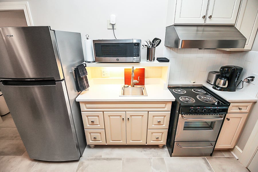 Exhaust fan in hood above range is externally vented. Coffee maker and toaster supplied.