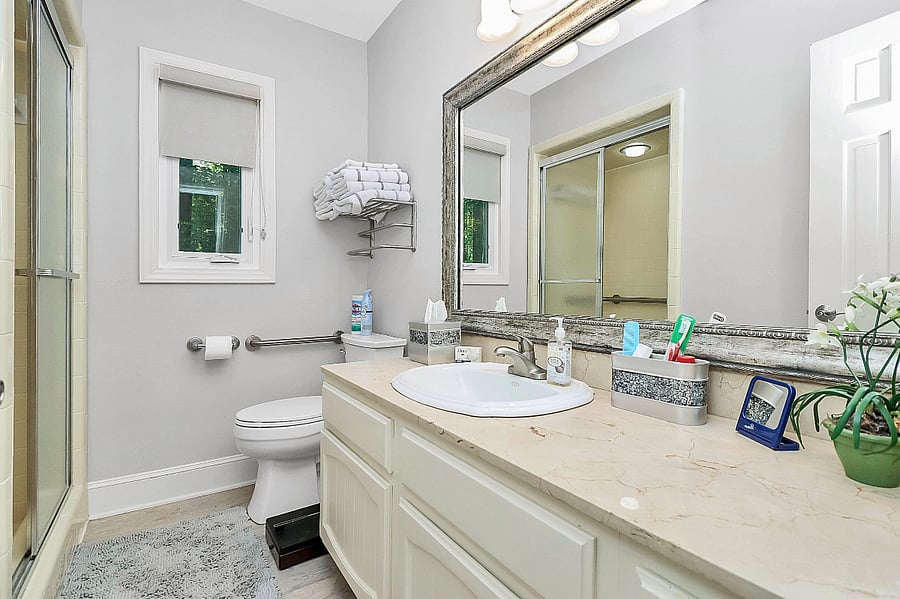 Handrail by the toilet. Bathroom scale.