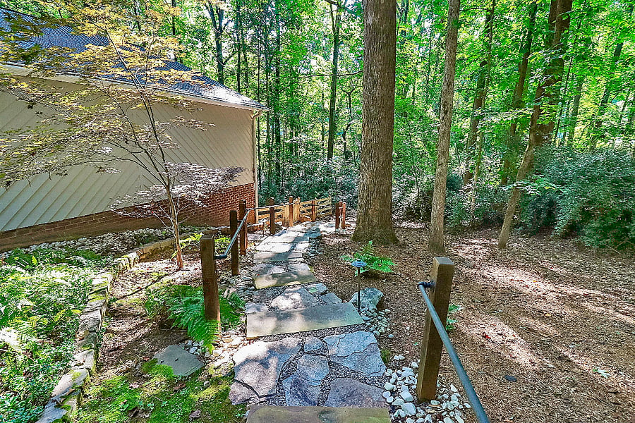 View of walkway down to gated side yard, from the private off street parking area