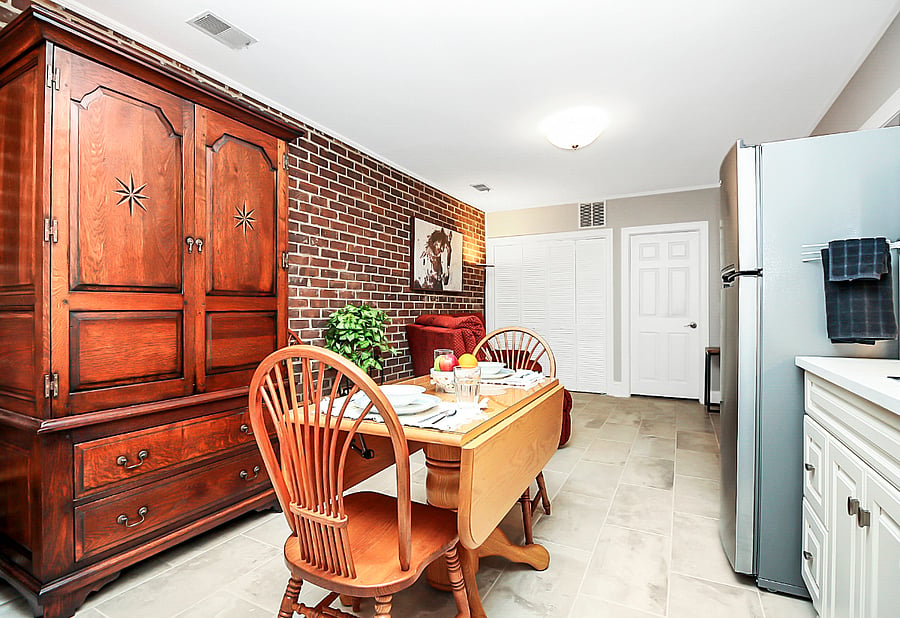 The armoire acts as a pantry and extra cabinet space for kitchen and dining ware