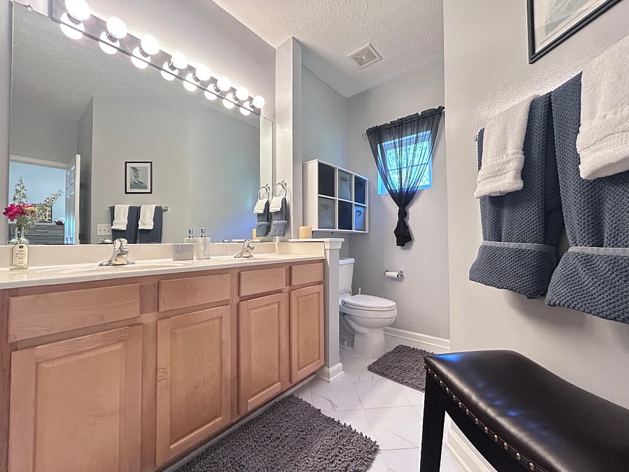 Primary bedroom en suite bathroom with wide entry & double vanity.