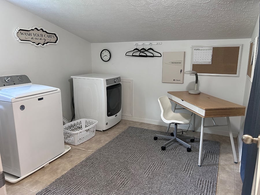 Huge laundry room with natural window & top quality WD plus work & storage (behind curtains) areas.