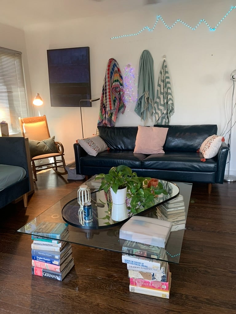 Living room with two couches and a reading nook with antique rocking chair.