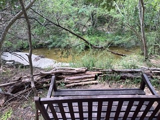 Bench with creek view in the neighborhood park.