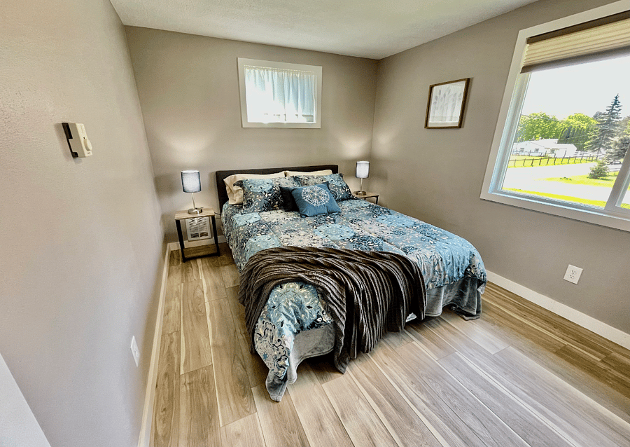 Main floor back bedroom with queen size bed.