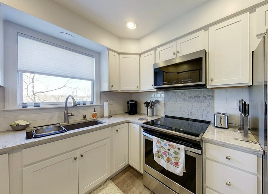 Galley kitchen stocked with everything that is needed for cooking. Also includes two bar stools for dining in kitchen at the counter.