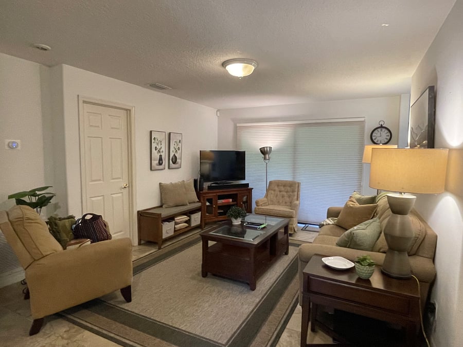 Largest bedroom behind closed door w en-suite 
Main living space
Outside screened in porch behind blinds.  Two bikes, lawn chairs and small grill available. 