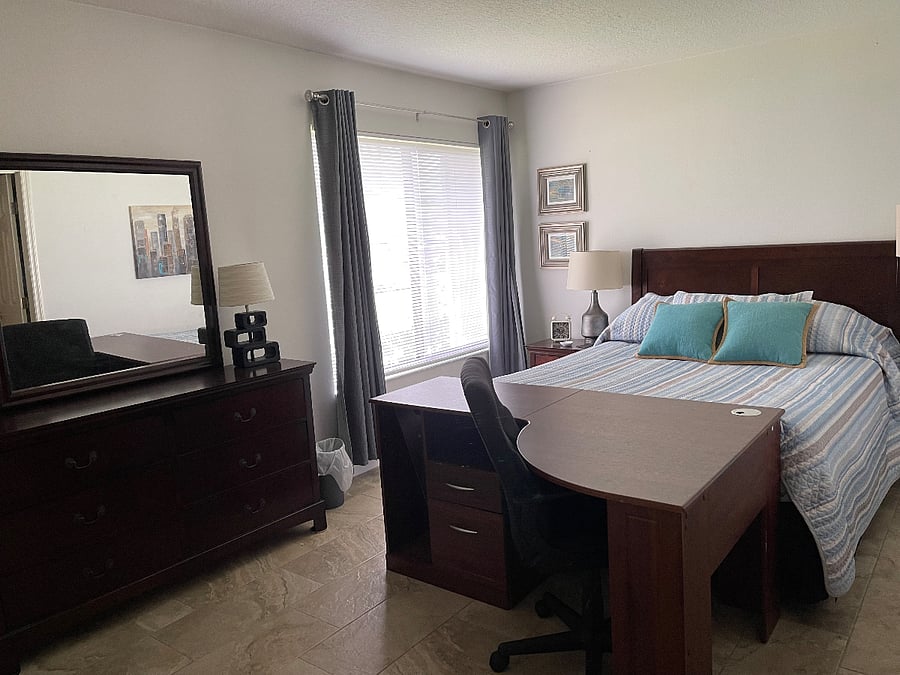 Front bedroom ensuite bath attached. Desk and large closet. Also outfitted with blackout curtains.  
Bath has access to den area 