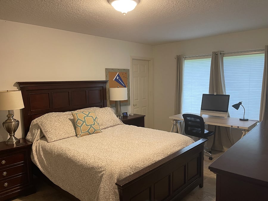 Master has large desk and two book shelves 