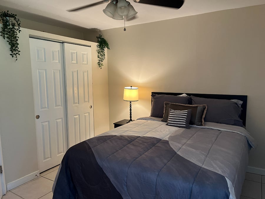 Quiet primary bedroom located at the rear of the home for added privacy.
