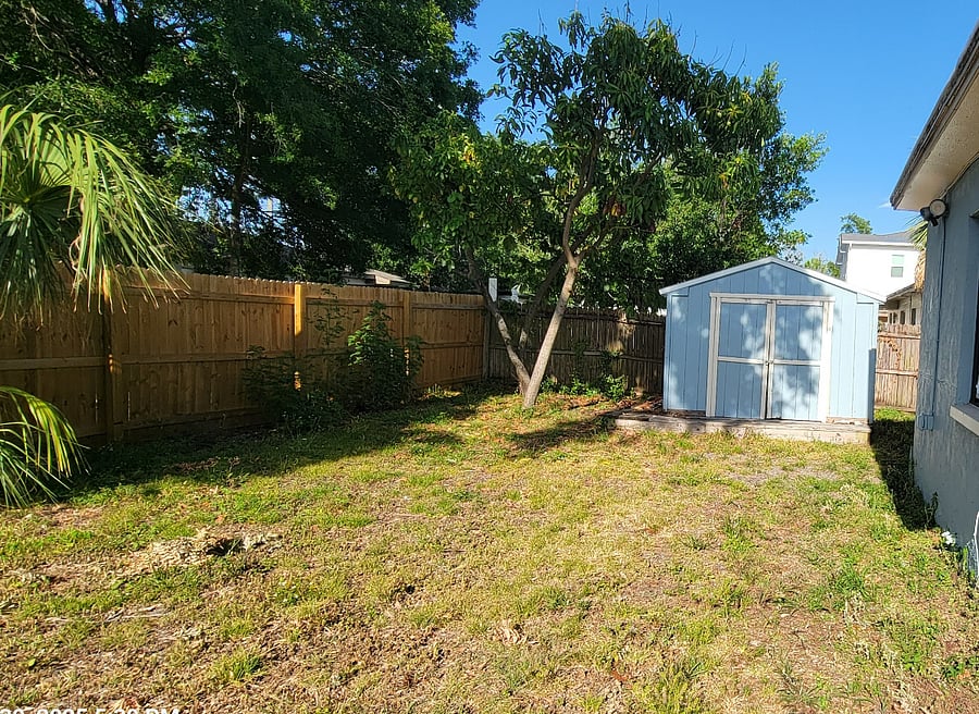 Large fenced backyard offering outdoor space and privacy in a quiet residential setting.
