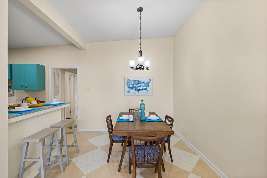 Side 1: Dining room with seating for 4 at the table and 2 at the bartop.