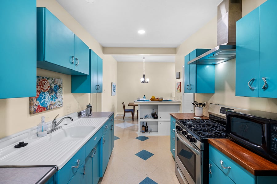 Side 1: Looking through kitchen from side door toward dining area