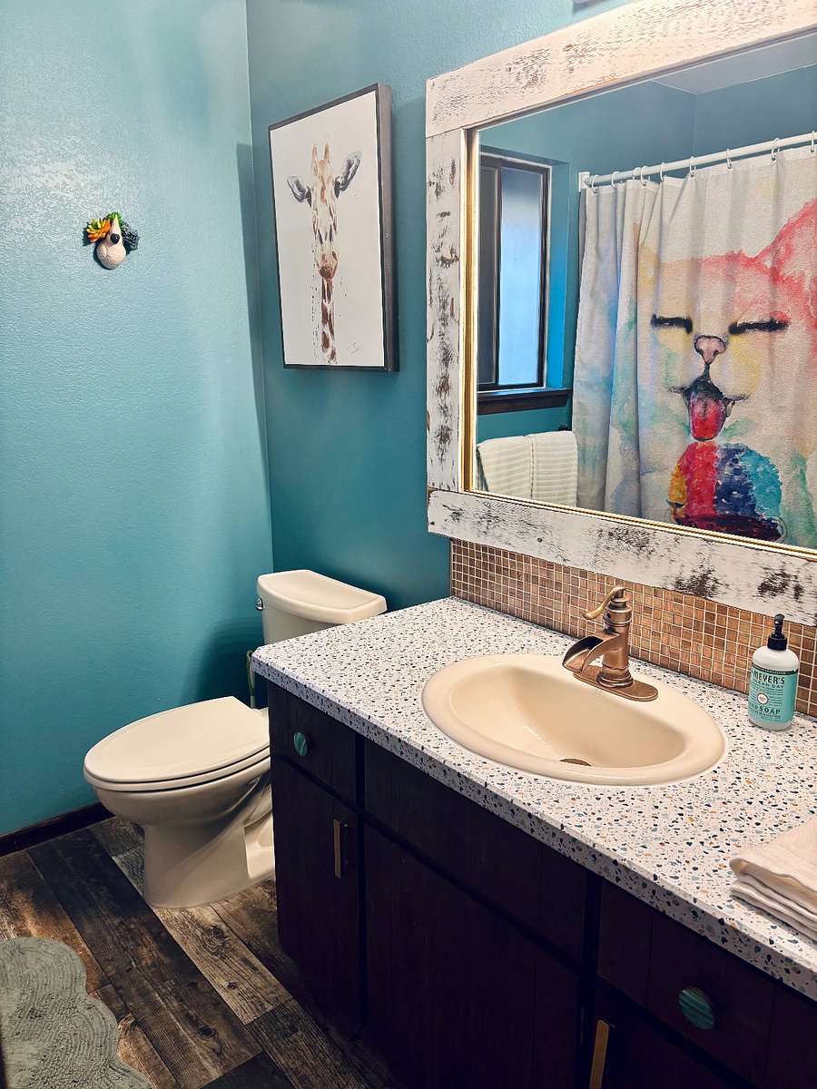 Upstairs bathroom located in hallway with new shower / tub.
