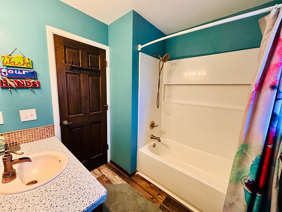 Upstairs bathroom located in hallway with new shower / tub.