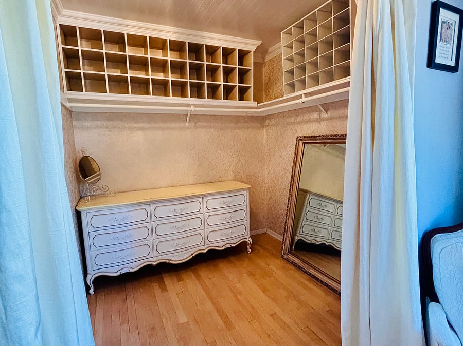 Primary bedroom walk in closet with full size dresser.