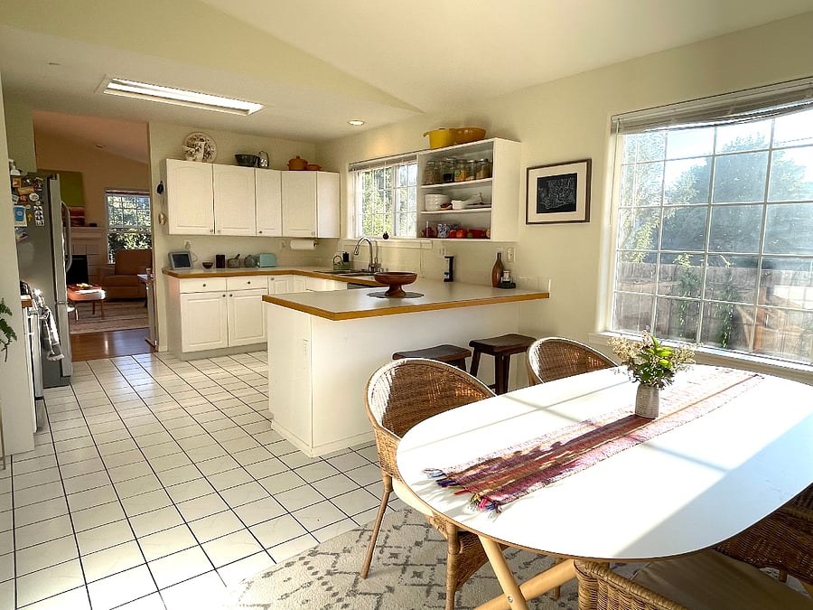 Dining room and kitchen with view of living room in background.