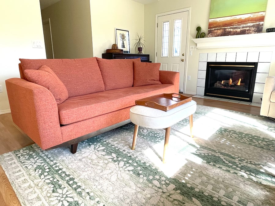 Living room with gas fireplace, back door to fenced yard and hallway to bedrooms.