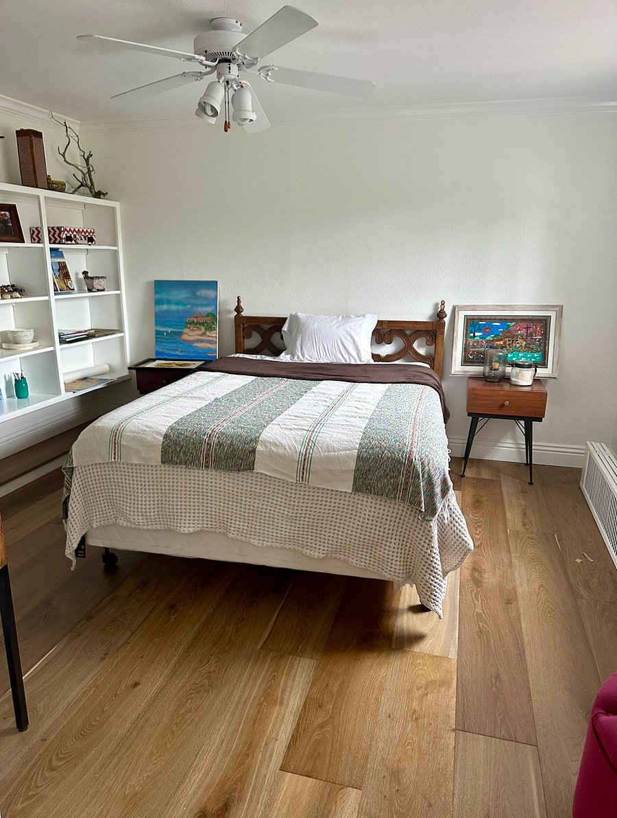 queen sized bed, built in shelving, and library