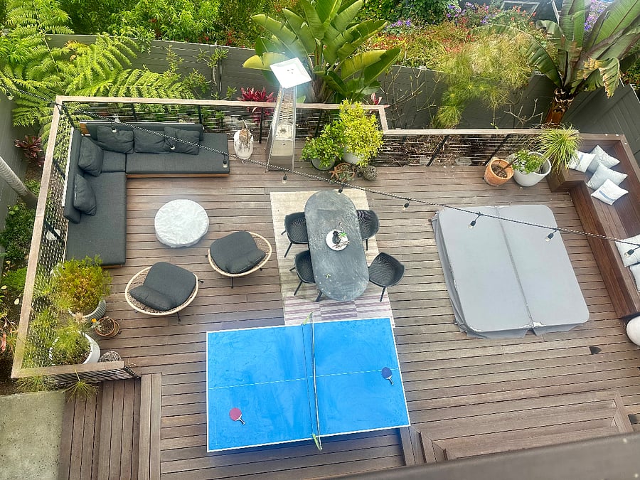 shared backyard with fire pit , jacuzzi, lounging area, dining space, and ping pong table
