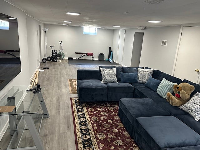 Basement LR w Large Sectional to Gym Area