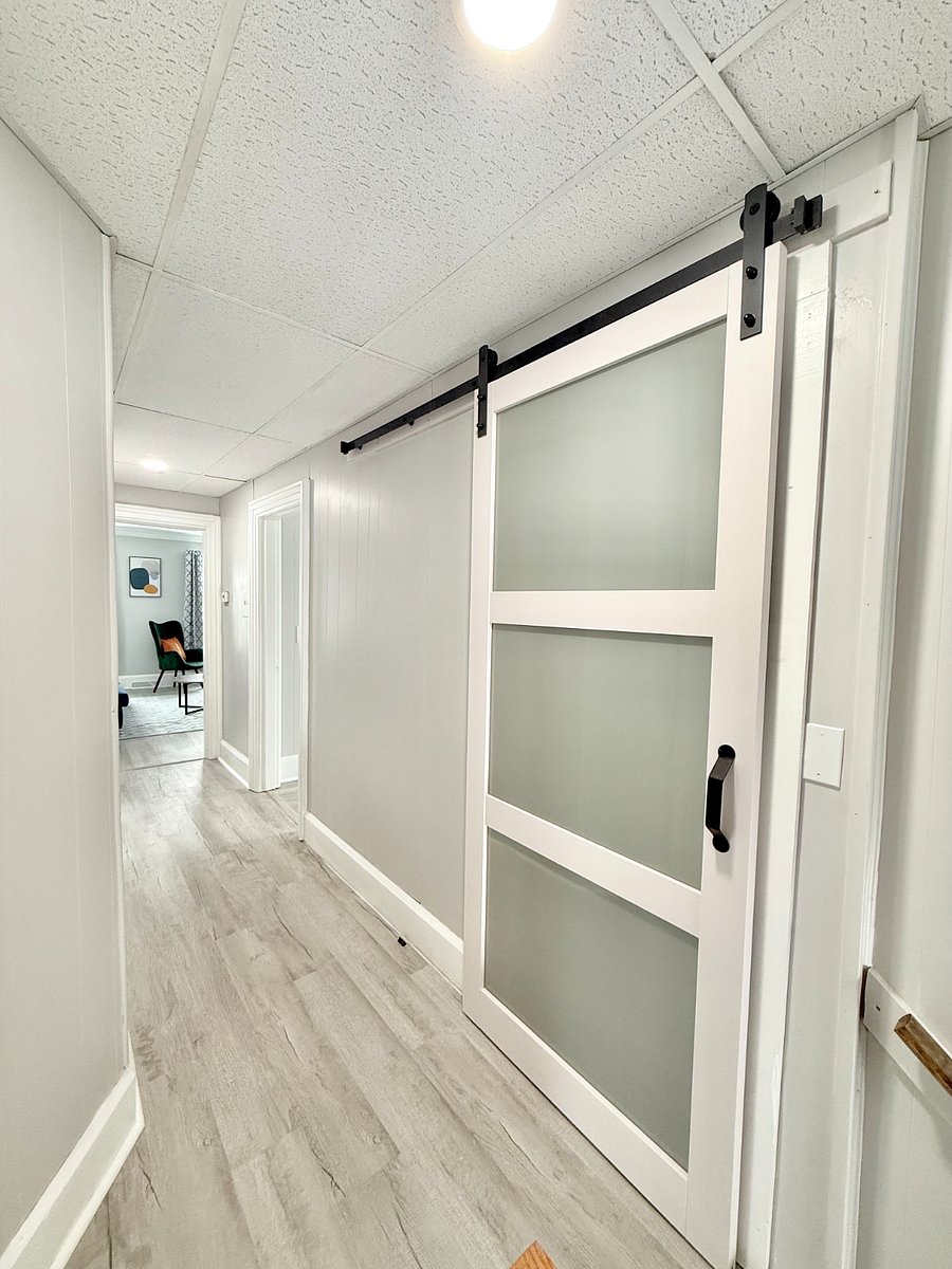 The beautiful modern sliding barn door adds a touch of style while saving space and making the bathroom feel roomier and more open.