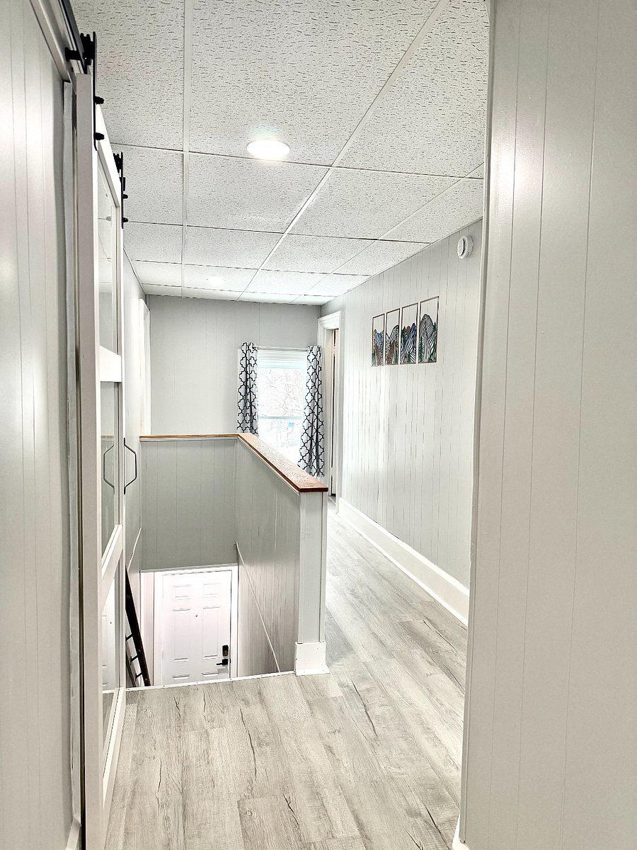 The hallway and stairs leading up to the unit are filled with plenty of natural light, creating a bright and welcoming atmosphere as you enter the space.