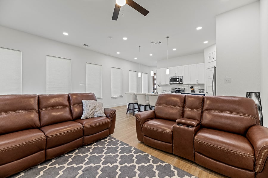Living room with power recliners and a 65" LG Smart TV