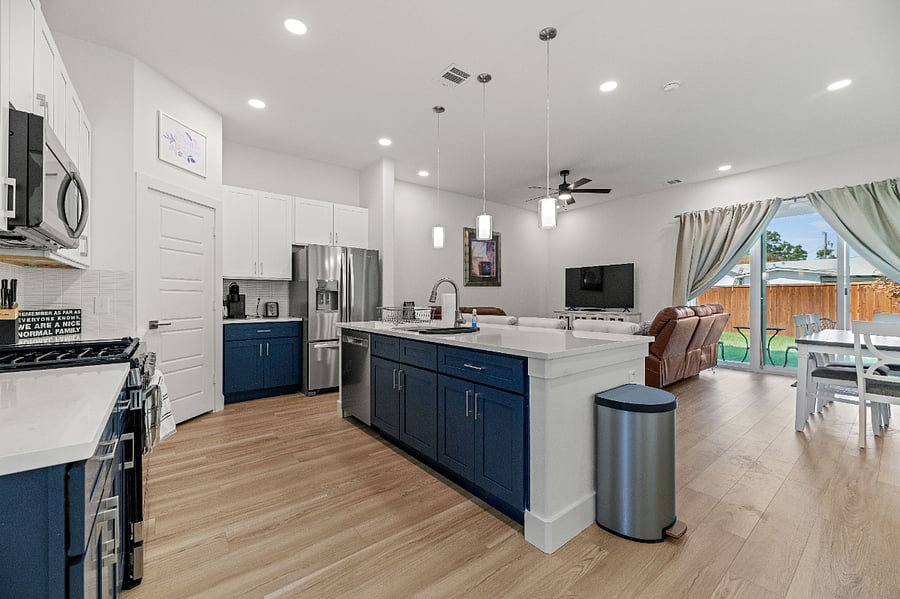 Open floor plan with 10 foot ceilings and light from the many windows and huge sliding glass door.