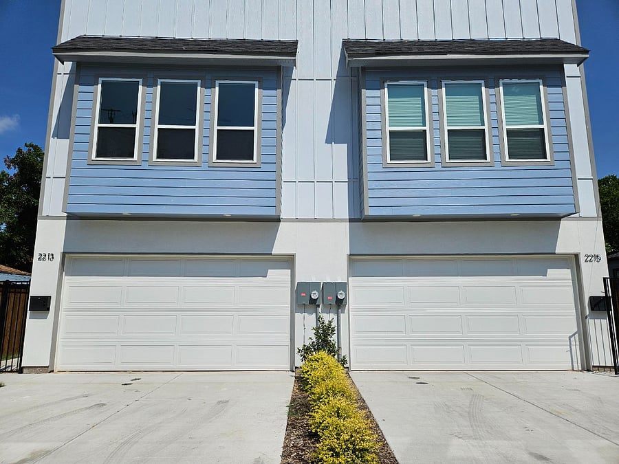 Front of house with 2-car driveway and garage directly off Sheridan Street with room for an additional car on the street