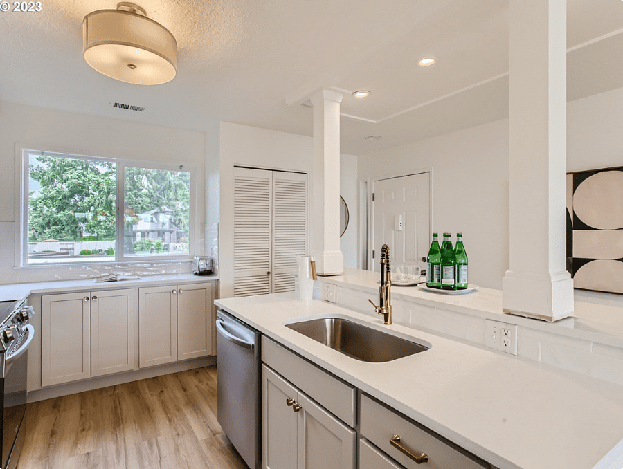 Beautiful kitchen sink and brand new dishwasher.