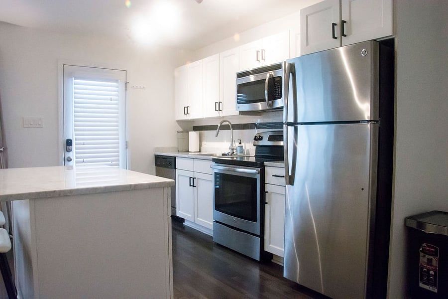 Kitchen with Dishwasher, Microwave, Refrigerator, Keurig Coffee Maker, Toaster, Pots, Pans, Dishes and Flatware for 6 people.