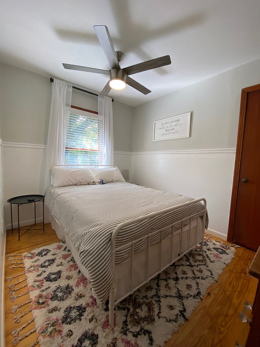 3rd bedroom w/ double bed and gray and white pinstripe duvet.