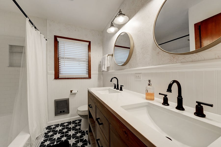 Hall bathroom w/ very trendy wallpaper, sink and tile. Little wall heaters I kept and work like champs! Don't worry it is still central heat :)