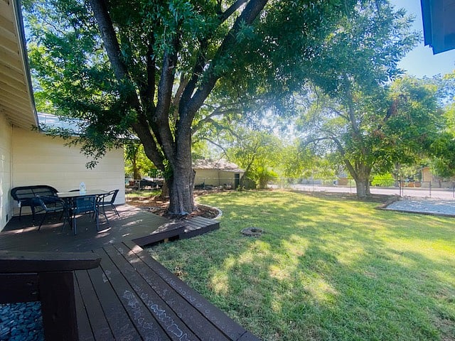 Deck w/ table and chairs and Loveseat (before was fully fenced). Yard is fully fenced on all sides and nice and shaded for the Texas heat. Perfect for your dog to run around!