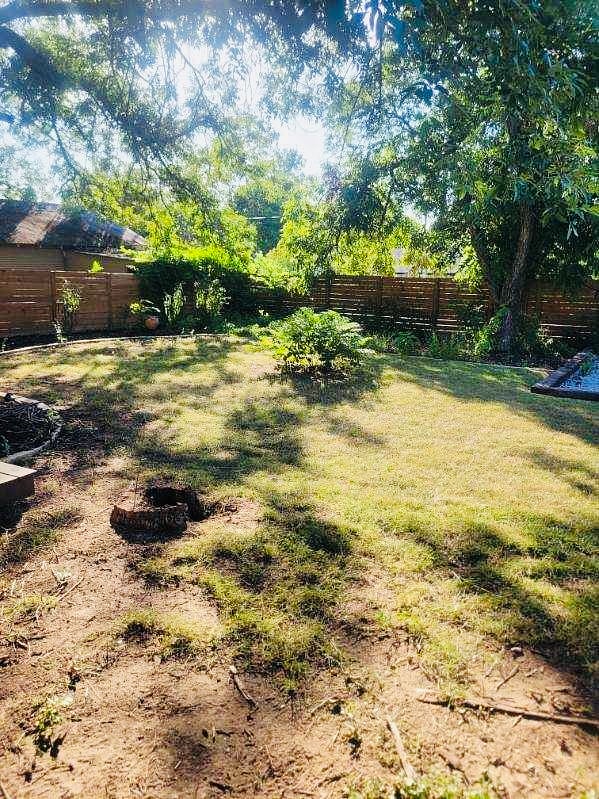 Yard nice and shaded w/ plants and trees