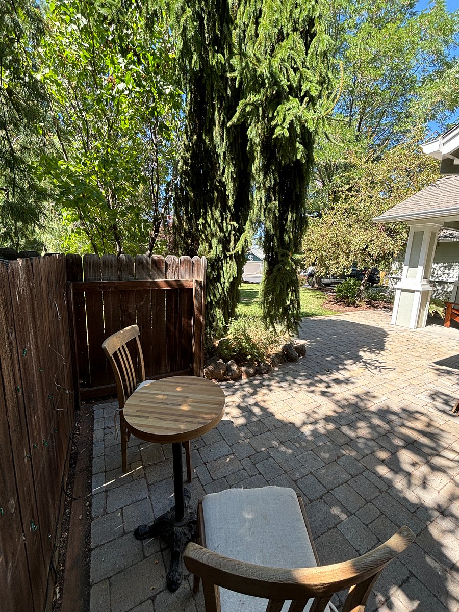 View from side entrance to backyard towards patio area.