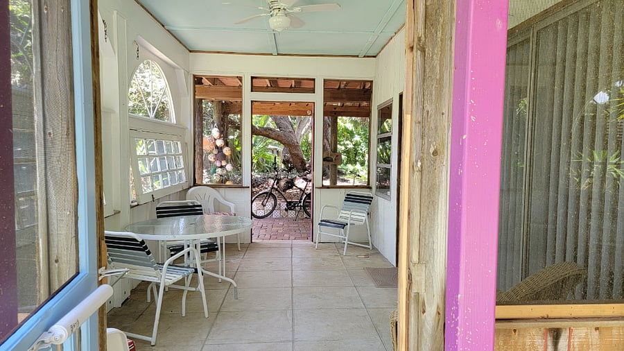 Screened porch looking west to covered brick patio