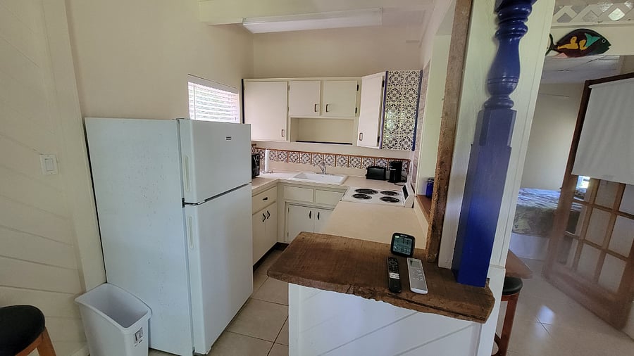 Full kitchen with top freezer refrigerator, 4 burner range with overn, microwave, toaster, K-cup coffee maker, dishes, cups and glasses, pots and pans, cooking utensiles, cutlery, Paper towels, dish soap and cleaning supplies.. All most would need.