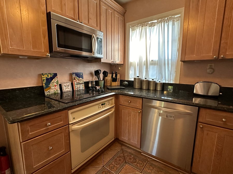 Fully appointed kitchen with cookware, dishes, cleaning supplies