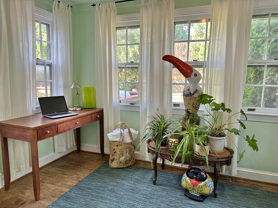 Sunny work-from-home space with view of garden and pool