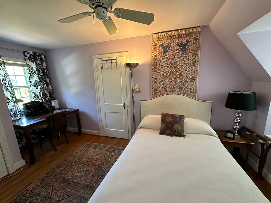 Comfortable second bedroom with work-from-home nook overlooking back yard and pool