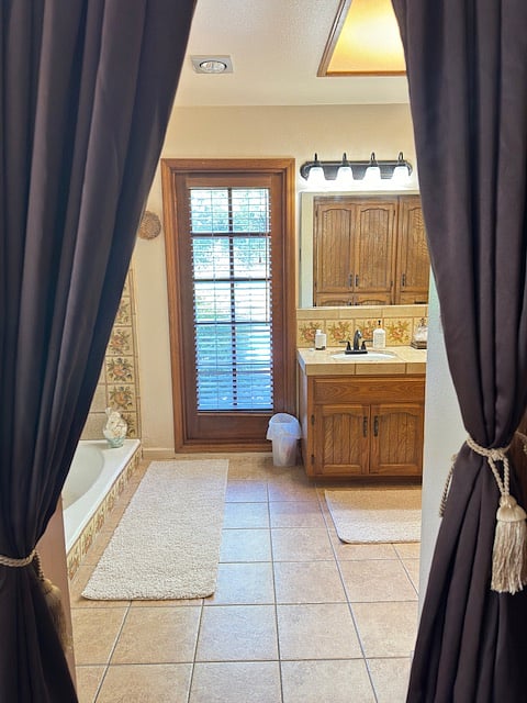 VIEW TO BACK POOL FROM MASTER BATHROOM INCLUDES SHOWER AND TUB