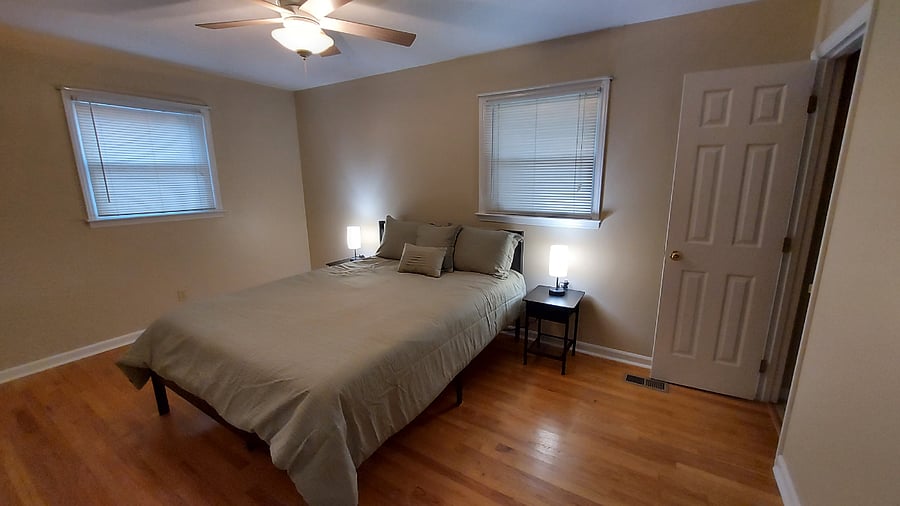 Master bedroom with queen bed and bathroom