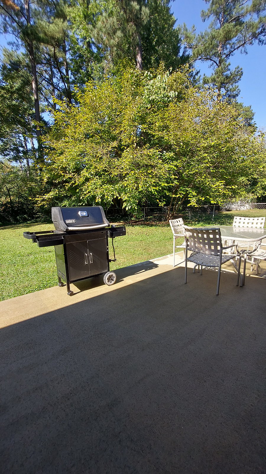 Outdoor patio, seating, area and gas grill, inside fully fenced back yard